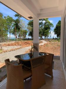 a patio with a table and chairs on a porch at Turtle's Cavern Oceanfront Resort in San Juan