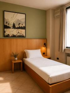a bedroom with a bed and a painting on the wall at SMART Hotel Argo in Orzinuovi