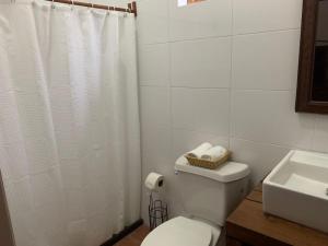 a white bathroom with a toilet and a sink at Antigua Mariana Hotel Boutique in Cedro +54 photos