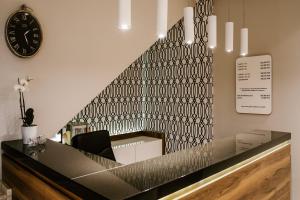 a lobby with a black and white patterned wall at Hotel Santin in Bełchatów
