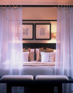 a bedroom with a bed with white pillows at The Sandpiper in Saint James