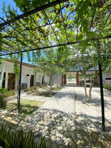 a courtyard of a house with trees at Villa GHANIA in Labuanbalat