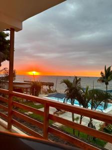 a sunset over the beach with a swimming pool at Costa Nueva Hotel in Zorritos
