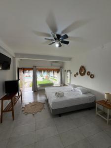 a bedroom with a bed and a ceiling fan at Costa Nueva Hotel in Zorritos