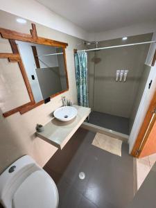 a bathroom with a toilet and a sink and a shower at Costa Nueva Hotel in Zorritos