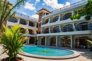 an exterior view of a building with a swimming pool at Sandat Mas Uluwatu in Uluwatu