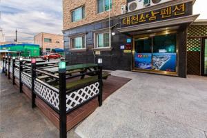 a row of benches in front of a building at Daecheon Sodam pension in Boryeong