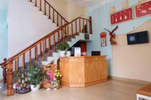 a room with a staircase and a counter with plants at Villa Aqua Da Lat in Da Lat