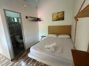 a bedroom with a large bed with a mirror at Quinto Hotel in Palomino