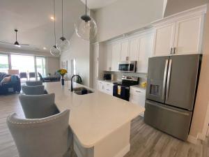 a kitchen with a counter and a refrigerator at Lakeview Luxe Penthouse in Rocky Mount
