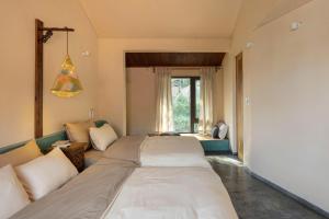 a bedroom with a large bed and a couch at HiuHill House in Cồn Giả Viên +28 photos