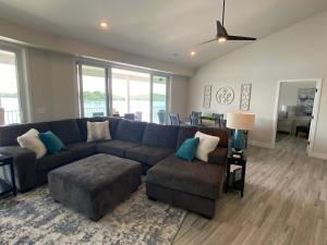 a living room with a large blue couch and chairs at Lakeview Luxe Penthouse in Rocky Mount +56 photos