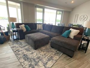 a living room with a blue couch and a rug at Lakeview Luxe Penthouse in Rocky Mount