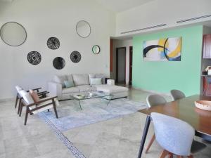 a living room with a couch and a table at B Esmeralda Pichilingue PentHouse in Acapulco