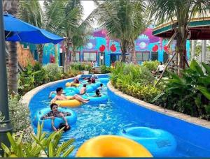 a group of people in a pool at a resort at Halo Motel Đồ Sơn in Ðố Sơn