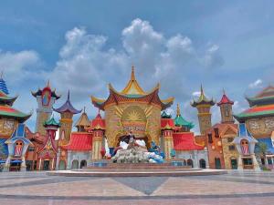 a disney castle with a lion statue in front of it at Halo Motel Đồ Sơn in Ðố Sơn