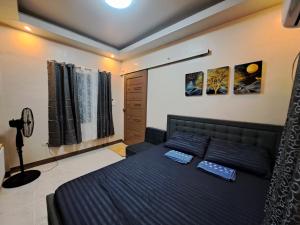 a bedroom with a bed with two pillows on it at Seaview Transient House in Bucayao