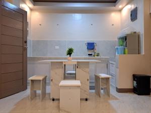 a kitchen with a island with stools in it at Seaview Transient House in Bucayao