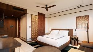 a bedroom with a white bed and a table at Thompson Seville, by Hyatt in Seville