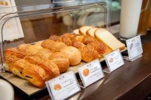 a display of pastries and breads on a counter at le Lac HOTEL KUSATSU in Kusatsu