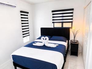 two white towels on a bed in a bedroom at MG Realty Luxury Stay in Miami