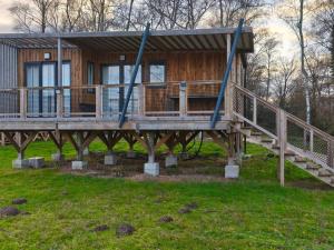 a log cabin with a porch and a deck at Chalet avec animaux admis - 4 pers. - API-1-52-2772 in Sainte-Montaine