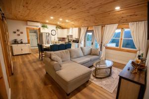 a living room with a couch and a table at Beautiful Bridgton Apartment in Bridgton