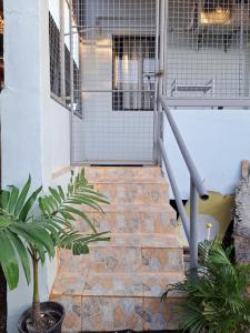 a set of stairs leading to a door with a gate at Seaview Transient House in Bucayao