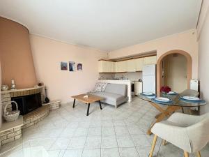 a kitchen and living room with a table and a couch at Seaside Apartment in Vrachati +16 photos