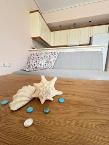 a starfish and seashells on a wooden floor in a bedroom at Seaside Apartment in Vrachati