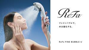 a woman washing her hair with a hair dryer at NAHA-WEST INN in Naha