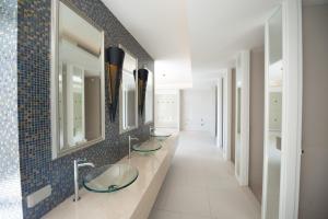 a bathroom with three sinks and mirrors on the wall at Caribbean Hotel Resort Pattaya in Pattaya South +44 photos
