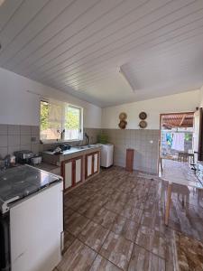 a large kitchen with a counter and a table at Fare Holidays - Raiatea in Taputapuapea +39 photos