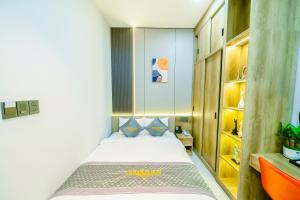 a small bedroom with a bed in a room at Tan Son Nhat Airport - Golden Sun Hotel in Ho Chi Minh City +24 photos