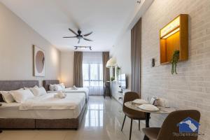 a hotel room with two beds and a table at Sunshine Residence Suites in Ayer Itam +55 photos