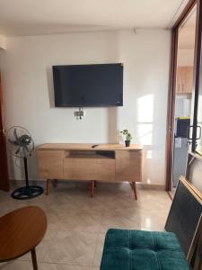 a living room with a flat screen tv on a wall at Departamento Ebenezer in Matarani +1 photo