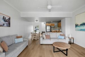 a living room with a couch and a table at Bella Mare Coolangatta Beachside Apartments in Gold Coast