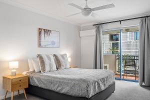 a white bedroom with a bed and a window at Bella Mare Coolangatta Beachside Apartments in Gold Coast +200 photos