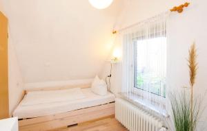 a small room with a bed and a window at Haushaelfte-Kuddel-104 in Böhl
