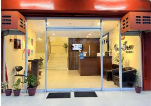 an entrance to a office with a glass door at Cris Inn - Bayugan in Bayugan City