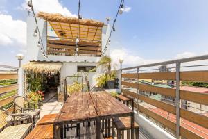 a balcony with a wooden table and chairs at Rain Airport Bed and Breakfast in Manila