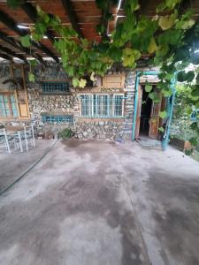 a large room with a stone wall and a table at Mountain House with Wonderful View in Las Compuertas