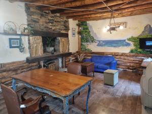 a living room with a table and a blue couch at Mountain House with Wonderful View in Las Compuertas