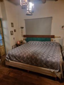 a bedroom with a large bed with a wooden headboard at Mountain House with Wonderful View in Las Compuertas +10 photos