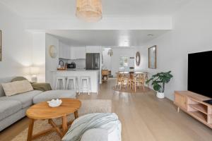a living room with a couch and a table at Bella Mare Coolangatta Beachside Apartments in Gold Coast