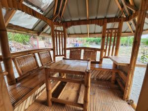 a pavilion with benches and tables on a boat at Beachfront Aircon Kubo for 4pax in Caba