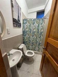 a bathroom with a toilet and a sink and a shower at New Experiences Valle sagrado in Urubamba +92 photos