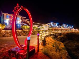a mirror with a red chair in front of a house at Jeonnam Cheongsando Yeohaeng Pension in Wando +36 photos