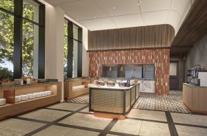a large kitchen with sinks in a room with windows at Premium hotel MONday MAIHAMA VIEW 2 in Tokyo