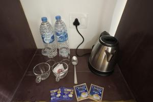 a counter with two bottles of water and wine glasses at Vagamon Hill Resort in Vagamon